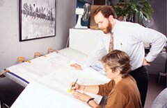 people working at a drafting table